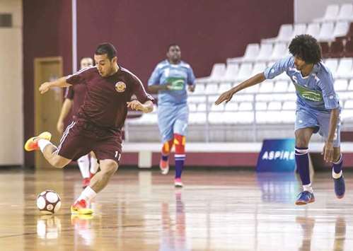 Action from the match between Qatar MOFA (in maroon) and South Africa embassy (in blue).