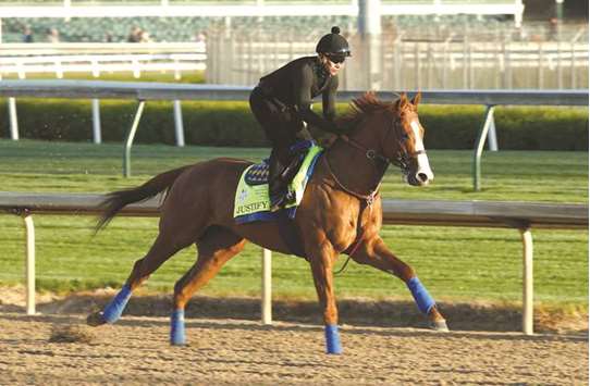Justify runs on the track during the morning training at Churchill Downs in Louisville, Kentucky, yesterday. (AFP)
