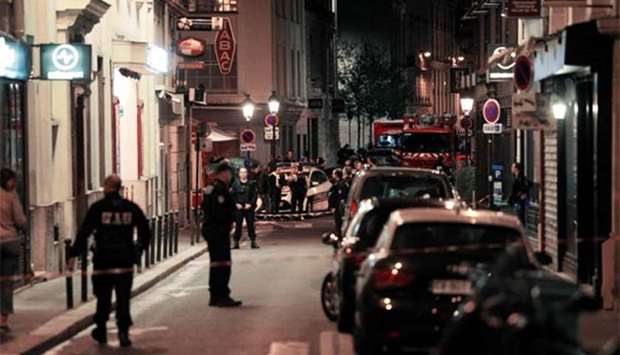 Policemen stand guard in a street in Paris after the knife attack.