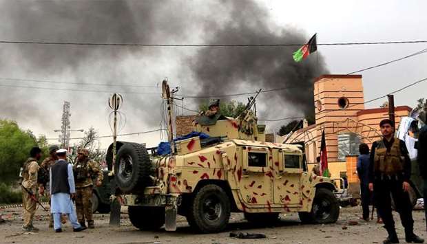 Afghan security forces keep watch during blasts and gunbattle at the site in Jalalabad city