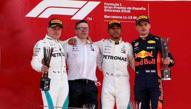 Mercedesu2019 Lewis Hamilton celebrates on the podium after winning the race with second placed Mercedesu2019 Valtteri Bottas (L) and third placed Red Bullu2019s Max Verstappen (R)