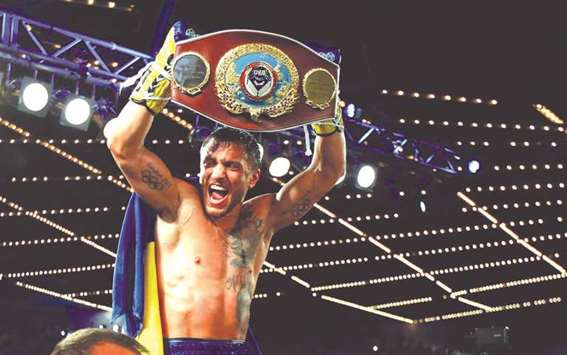 In this June 11, 2016, picture, Vasyl Lomachenko holds the championship belt after defeating Roman Martinez by knockout in their Junior Lightweight WBO World Championship bout at Madison Square Garden in New York City.