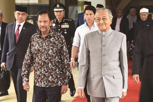 Prime Minister Mahathir Mohamad walking with Bruneiu2019s Sultan Hassanal Bolkiah (front left) upon his visit to the Perdana Leadership Foundation in Putrajaya. The 92-year-old Mahathir is now the worldu2019s oldest elected leader after winning the countryu2019s general election on May 9.