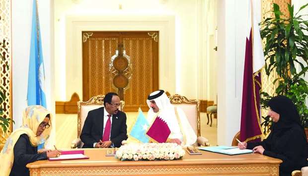 His Highness the Amir Sheikh Tamim bin Hamad al-Thani and President of Somalia, Mohamed Abdullahi Farmaajo, witnessing the signing of an agreement between Qatar and Somalia at the Amiri Diwan