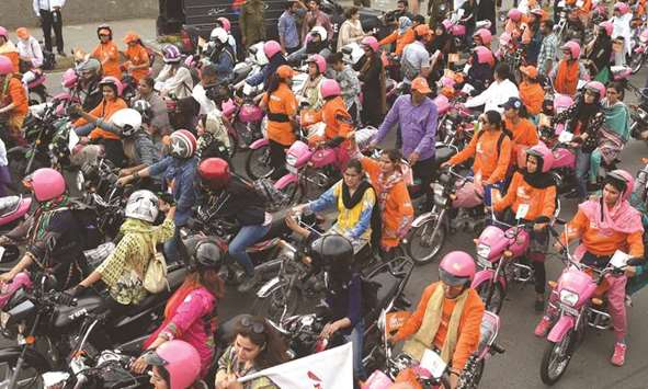In this picture taken on Sunday, women ride pink motorcycles during the rally in Lahore. The Punjab government launched the u2018Women on Wheelsu2019 scheme with the aim of empowering women in society.