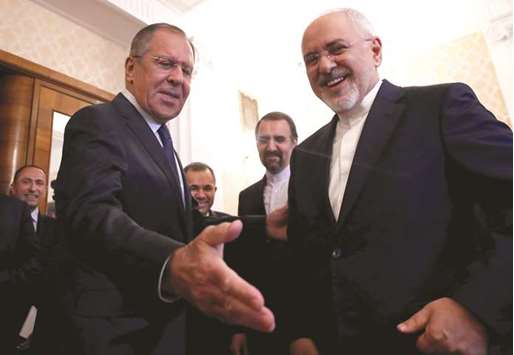 Russian Foreign Minister Sergei Lavrov invites his Iranian counterpart Mohamed Javad Zarif to have a seat during their meeting in Moscow, yesterday.