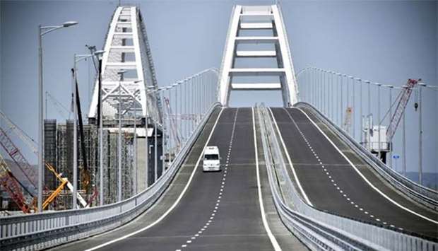 A vehicle drives along a bridge that connects the Russian mainland with the Crimean Peninsula across the Kerch Strait, on Tuesday.