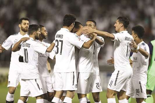 Al Sadd players celebrate their win over Al Ahli during the first leg of their Round of 16 clash in Doha earlier this month.