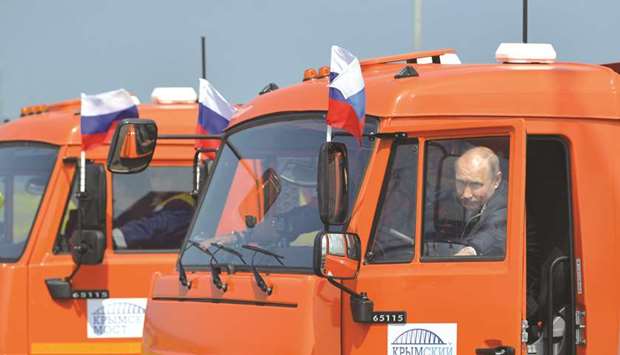 Putin gets behind the wheel of a Kamaz truck during the ceremony to open the bridge, which was constructed to connect the Russian mainland with the Crimean Peninsula, near the Taman Peninsula in Krasnodar Region, Russia.
