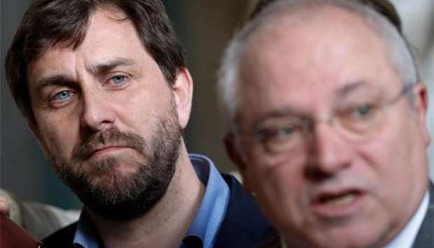 Former Catalan ministers Lluis Puig Gordi and Antonio Comin talk to the media after appearing in court in Brussels on Wednesday.