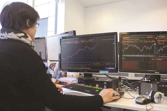 A stock trader works at the London Stock Exchange. The FTSE 100 rose 0.2% to 7,73420 points yesterday.