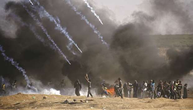 Tear gas is fired at protestors by Israeli forces near the border between the Gaza strip and Israel, east of Gaza City on May 14, 2018, following the the controversial move to Jerusalem of the United States embassy.