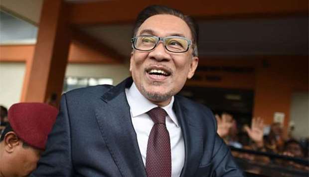 Anwar Ibrahim greets supporters after his release from the Cheras Hospital Rehabilitation in Kuala Lumpur on Wednesday.