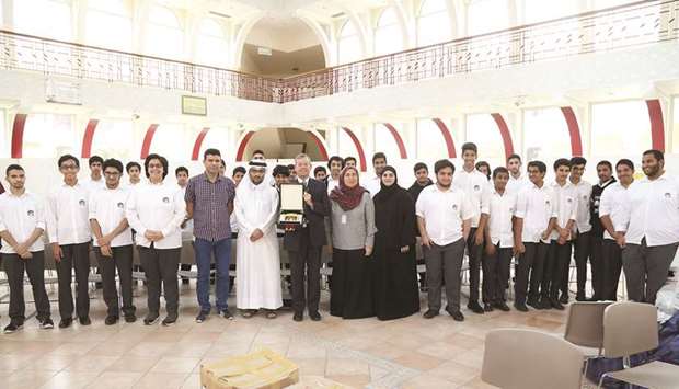Staff and students of Qatar Academy with QC officials at the launch of the Ramadan food baskets programme.