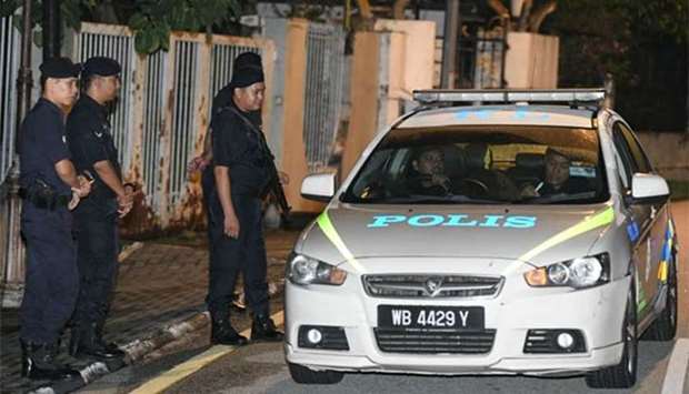 Royal Malaysia Police standing at the entrance of former prime minister Najib Razak's residence in Kuala Lumpur late on Wednesday.