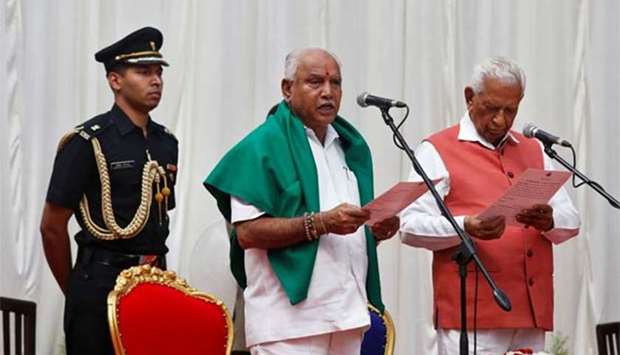 Bharatiya Janata Party leader B. S. Yeddyurappa is administered the oath as Chief Minister of the southern state of Karnataka by Governor Vajubhai Vala at the Governor's house in Bengaluru on Thursday.