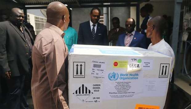 Congolese Health Ministry officials carry the first batch of experimental Ebola vaccines in Kinshasa