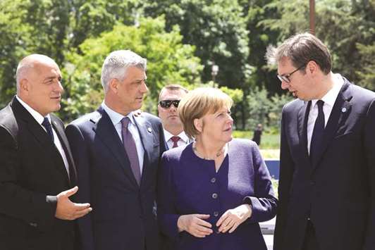 From left: Bulgarian Prime Minister Boyko Borisov; Kosovou2019s President Hashim Thaci; German Chancellor Angela Merkel and Serbian President Aleksandar Vucic speak together prior to the family photo during an EU-Western Balkans Summit in Sofia yesterday. The EUu2019s 28 leaders meeting in the Bulgarian capital made a rare demonstration of unity in the face of what EU President Donald Tusk called the u201ccapricious assertivenessu201d of the Trump administration.