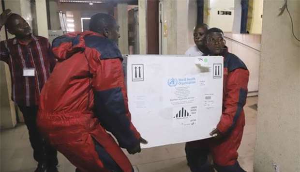 Congolese Health Ministry officials carry the first batch of experimental Ebola vaccines in Kinshasa earlier this week.
