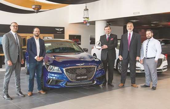 Officials with the Best Mid-Size Premium Sport Sedan award won by the Genesis G80 Sport.