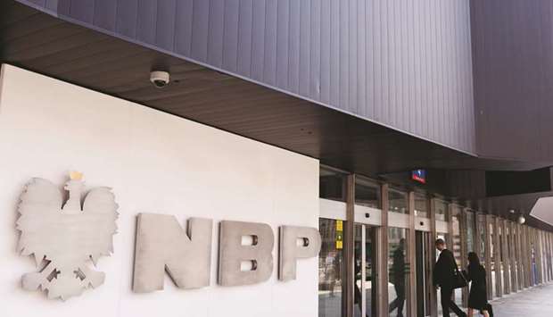 Visitors enter the headquarters of Polandu2019s central bank in Warsaw. The National Bank of Poland is less of an outlier on monetary tightening now that its counterparts from Japan to Sweden and beyond are choosing to stick with easy policy for longer.