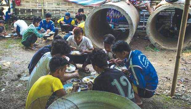 Internally displaced people eat meals at a temporary shelter at a church compound in Tanghpre village outside Myitkyina, Kachin state of Myanmar.