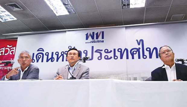 Pheu Thai party members Watana Muangsook, left, Chaturon Chaisaeng, centre, and Chusak Sirinul speak at a press conference in Bangkok yesterday, ahead of the fourth anniversary of the May 22 Thai military coup.