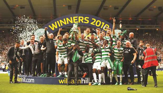 Celtic players celebrate with the trophy after winning the Scottish Cup at the Hampden Park in Glasgow, Britain, yesterday. (Reuters)