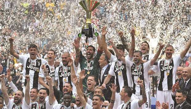 Juventusu2019 captain Gianluigi Buffon (centre) lifts the trophy as he celebrates with teammates after winning the Serie A title at the Allianz Stadium in Turin, Italy, yesterday. (AFP)