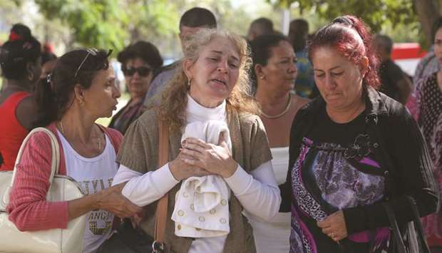 Relatives of victims of the Boeing 737 plane that crashed after taking off from Havanau2019s main airport on Friday mourn as they leave the Legal Medical Institute in Havana yesterday.