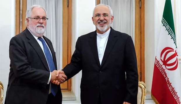 Iran's Foreign Minister Mohammad Javad Zarif shakes hands with the EU's Climate Action and Energy Commissioner Miguel Arias Canete during their meeting in Tehran on Sunday.