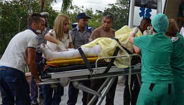 A survivor of a plane crash is being brought to a hospital in Havana.