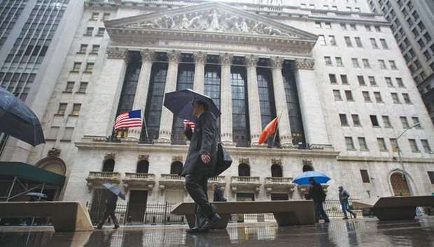 Pedestrians walking past the New York Stock Exchange (file). The S&P 500 bank sector index beat first quarter earnings estimates by 3.1%, and Wall Streetu2019s 2018 earnings growth consensus for the sector climbed to 32.2% in early May from 28.4% on April 1.
