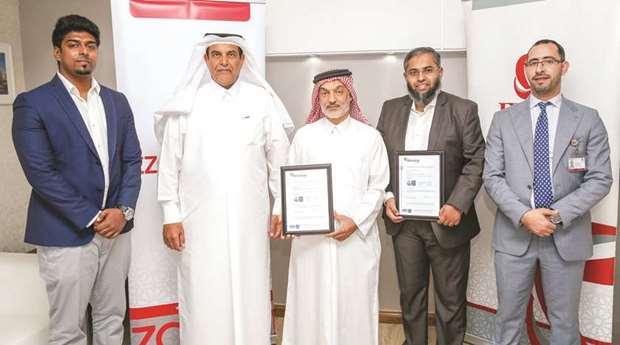 Ezdan officials with ISO certification.