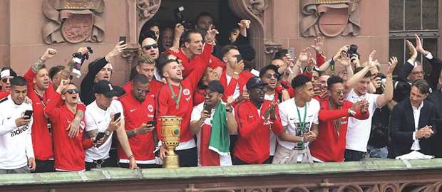 Eintracht Frankfurtu2019s players celebrate after winning the German Cup final on the balcony of city hall at the Roemerberg square in Frankfurt yesterday. (AFP)