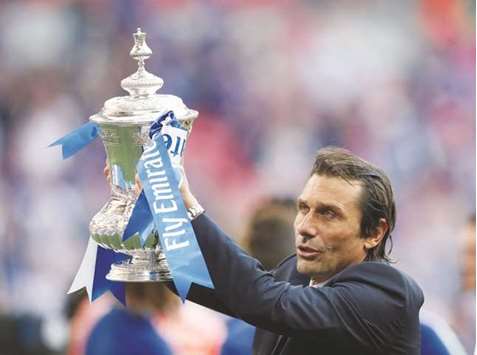 Chelsea manager Antonio Conte celebrates winning the FA Cup final with the trophy  on Saturday. (Reuters)