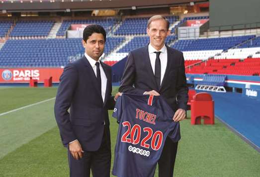 New PSG coach Thomas Tuchel (right) poses with club president Nasser al-Khelaifi during his unveiling at Parc des Princes in Paris yesterday. (Reuters)