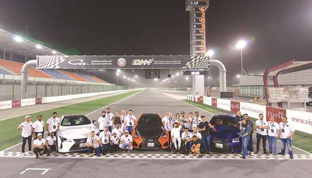 Participants of the launch event for the countryu2019s first official Lexus F Club pose at the Lusail International Circuit.
