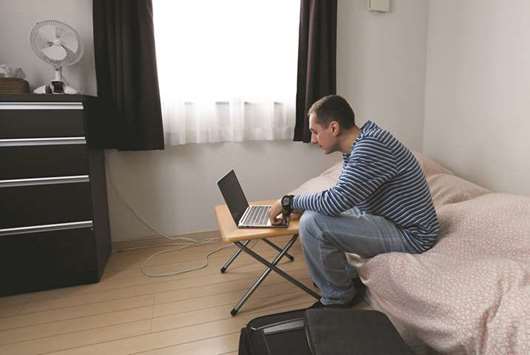 Rental user Max Ikeda, a Ukrainian-Japanese living in Hiroshima, relaxing in his room at a rental house in Tokyo.
