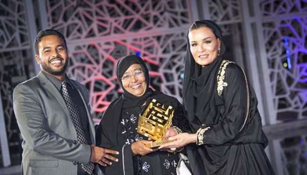 Her Highness Sheikha Moza bint Nasser presents the award to Swar al-Dahab Ali (left) at the convocation ceremony. Picture: AR Al-Baker/HHOPL