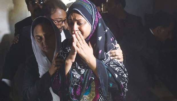 In this picture taken on April 7, Asma Nawab is overwhelmed by emotion as she enters her house in Karachi after her release.