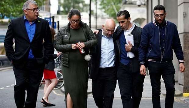 Marcio and Andreia Gomes, parents of Logan Gomes, are comforted as they arrive for a commemoration hearing at the opening of the inquiry into the Grenfell Tower disaster, in London on Monday.