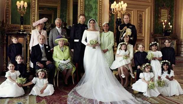 A picture released by Kensington Palace on behalf of The Duke and Duchess of Sussex on Monday shows Britain's Prince Harry, Duke of Sussex, and his wife Meghan, Duchess of Sussex, posing for an official wedding photograph with (left to right back row) Britain's Camilla, Duchess of Cornwall, Britain's Prince Charles, Prince of Wales, Doria Ragland, the Duchess of Sussex's mother, Britain's Prince William, Duke of Cambridge, (middle row left to right): Master Jasper Dyer, Britain's Prince Philip, Duke of Edinburgh, Britain's Queen Elizabeth II, Britain's Catherine, Duchess of Cambridge, Princess Charlotte of Cambridge, Prince George of Cambridge, Miss Rylan Litt, Master John Mulroney and (front row) Miss Ivy Mulroney, Master Brian Mulroney, Miss Florence van Cutsem, Miss Zalie Warren and Miss Remi Litt in the Green Drawing Room, Windsor Castle, in Windsor on Saturday.