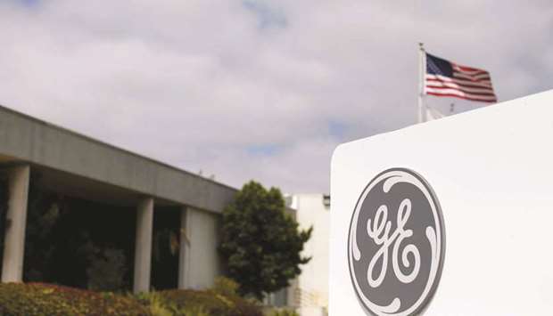 The logo of General Electric is shown at its subsidiary company GE Aviation in Santa Ana, California (file). GE chief executive officer John Flannery is taking the biggest step yet in his plan to revitalise the beleaguered manufacturer, agreeing to merge its century-old locomotive business with Wabtec Corp in a deal valued at $11.1bn.