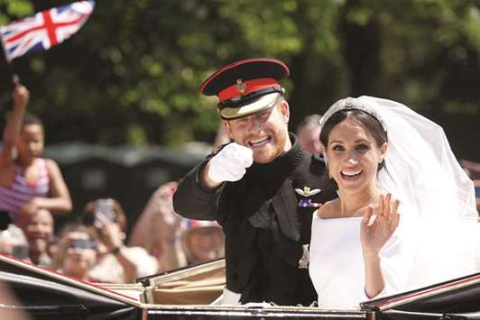 DREAM COME TRUE: Britainu2019s Prince Harry and his wife Meghan wave as they ride a horse-drawn carriage after their wedding ceremony at St Georgeu2019s Chapel in Windsor Castle in Windsor.  Reuters