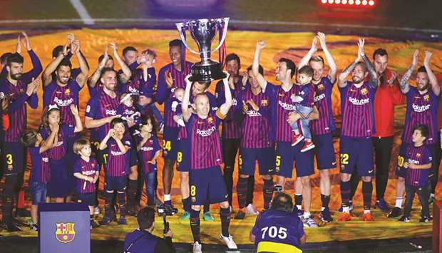 Barcelonau2019s Andres Iniesta and teammates celebrate with the La Liga trophy after their final league match against Real Sociedad at Camp Nou, Barcelona, Spain on Sunday night. (Reuters)