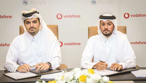 Sheikh Hamad and al-Subeai during the signing of the QR911mn credit facility deal, which will be used to accelerate the telecommunication companyu2019s fixed services rollout and 5G deployment across the country.