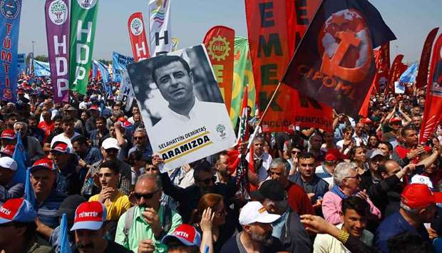 A demonstrator holds up a poster of Selahattin Demirtas, the jailed former co-leader of the pro-Kurdish Peoples' Democratic Party (HDP), during a May Day rally in Istanbul, Turkey.