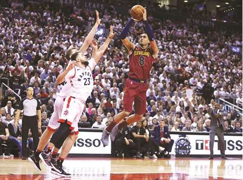 Jordan Clarkson of the Cleveland Cavaliers shoots the ball as Jonas Valancianas and Fred VanVleet (left) of the Toronto Raptors defend in the second-half of Game One of the Eastern Conference semi-finals during the 2018 NBA Playoffs at Air Canada Centre in Toronto. (AFP)