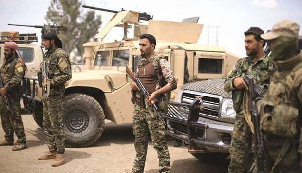 Fighters of Syrian Democratic Forces (SDF) are seen in Deir al-Ezzor, yesterday.